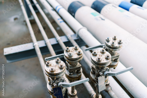 Organized industrial pipes and valves system installed inside factory.
