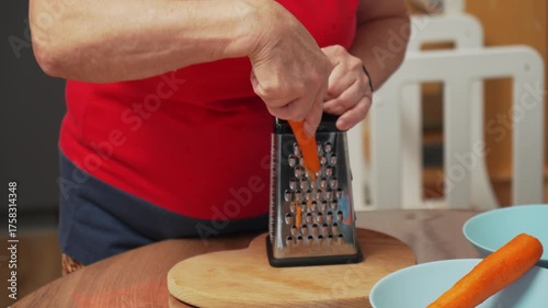 Grating carrots for a fresh salad in a cozy kitchen on a sunny afternoon