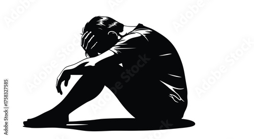 Silhouette of a person sitting with their head in their hands