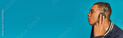 Canvas Print Young man in vibrant attire enjoys music, lost in blissful moments of self expre