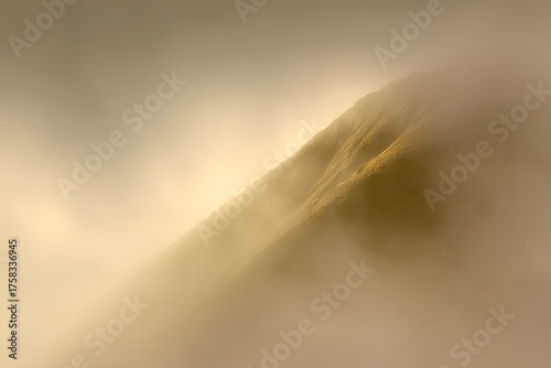 Mountain peak obscured by thick, ethereal golden mist