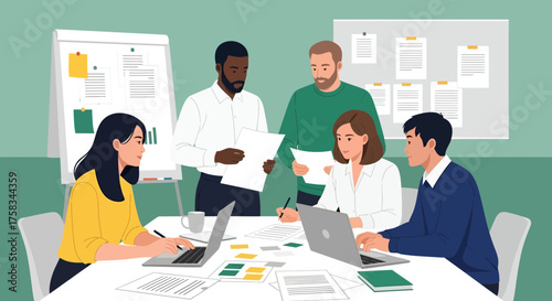 Diverse team collaborating in a meeting with laptops and papers