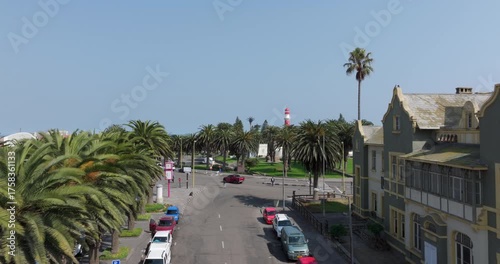 Aerial drone shot, flying over the streets of Swakopmund and the historic Swakopmund Lighthouse in Namibia.	
