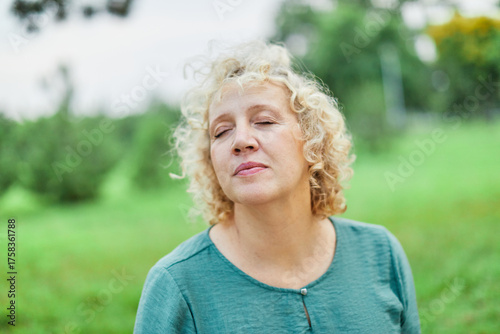 Portrait of a beautiful happy mid aged blonde mature woman outdoors
