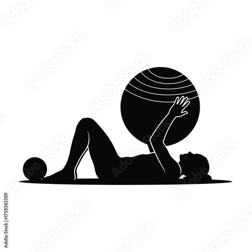 Silhouette of a woman lying down on a mat while exercising with a large exercise ball above her