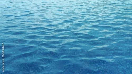 Close-up video of sunlight reflecting on blue swimming pool surface with soft wind ripples. Perfect for background, relaxation, spa, or summer concept.