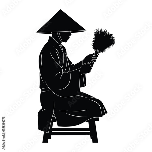 A silhouette of a person in traditional clothing sitting on a stool holding a feather fan