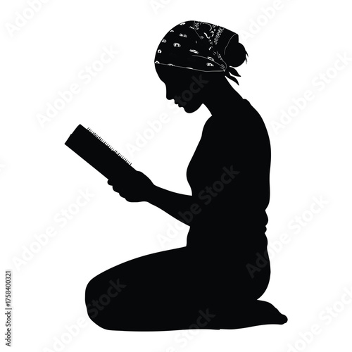 Silhouette of woman kneeling and reading a book with a bandana on her head in black and white