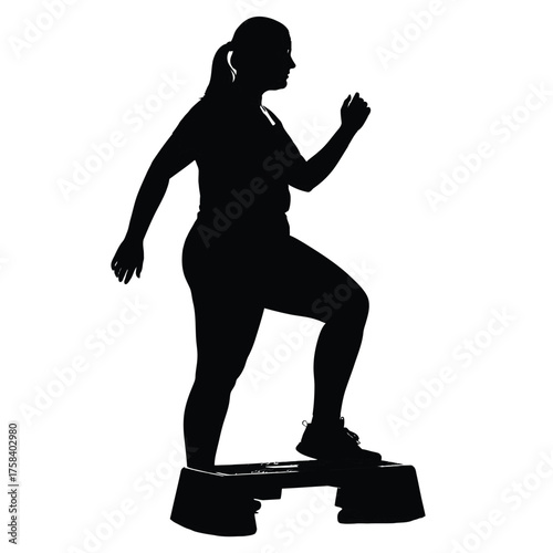 Silhouette of woman stepping onto step aerobics platform in fitness exercise routine workout