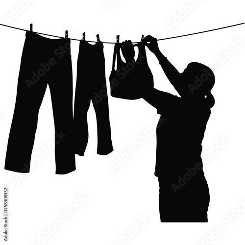 Silhouette of person hanging clothes on a clothesline with pants and a tank top in black and white