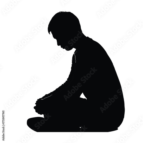 Silhouette of a person sitting cross legged with hands clasped in a contemplative pose