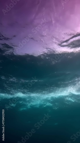 Vertical breathtaking underwater view of crashing waves