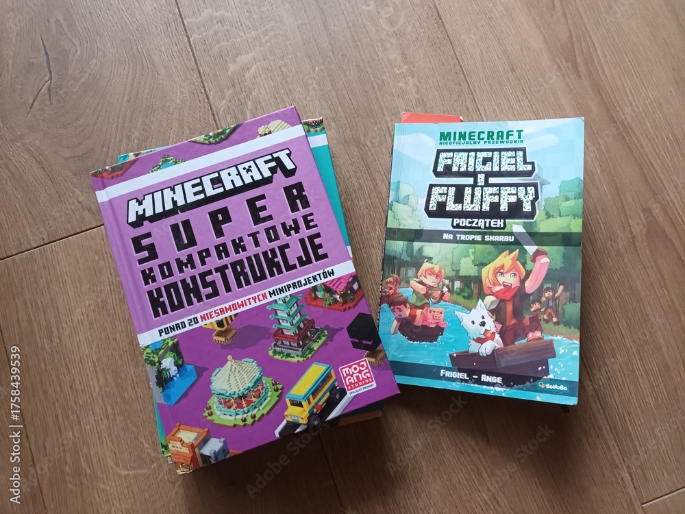 Naklejka premium Two Minecraft Books on a Wooden Surface Super Kompaktowe Konstrukcje and Friciel i Fluffy