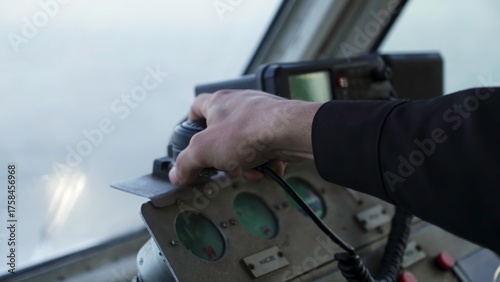 Captain using vhf radio and adjusting controls on ship's bridge. Clip