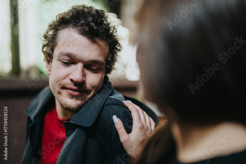Quadro em tela A man smiles warmly while a supportive hand rests on his shoulder, expressing care and encouragement