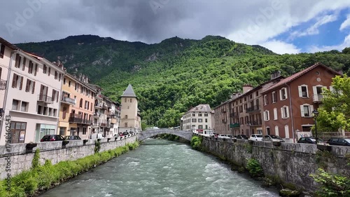 Historic Town of Moûtiers with Stone Bridge over River in the French Alps