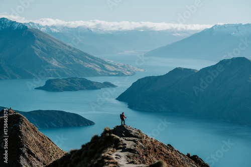 Hiker Standing on Roys Peak Viewpoint Overlooking Lake Wanaka and Southern Alps, New Zealand