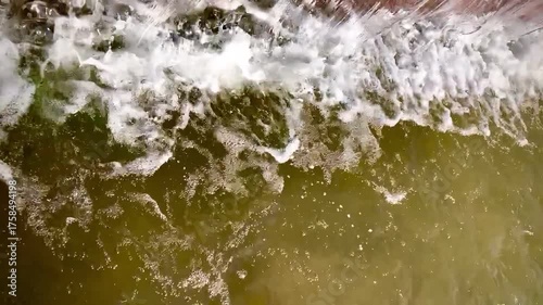 a smooth, even stream of water falling from the edge of a cliff or ledge