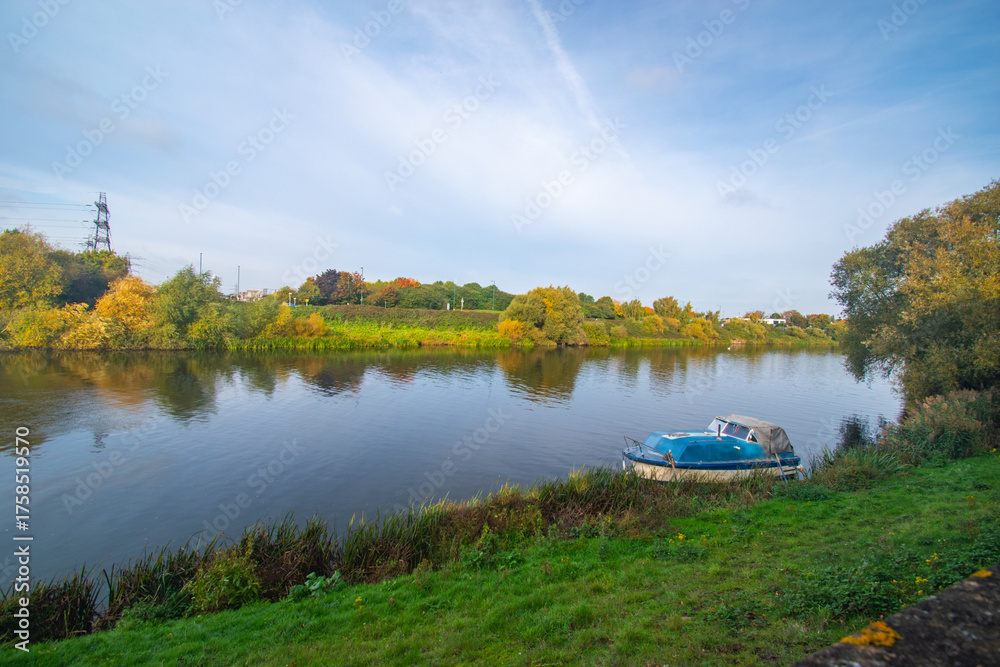 Fototapeta premium A moored small boat on the river Trent in Nottingham, UK.