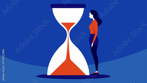 Woman standing next to a large hourglass