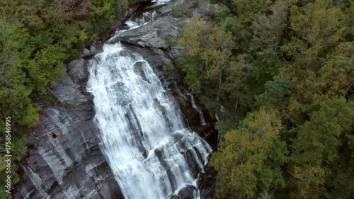 Aerial flyover of Rainbow Falls, a massive waterfall in the Blue Ridge Mountains of North Carolina.