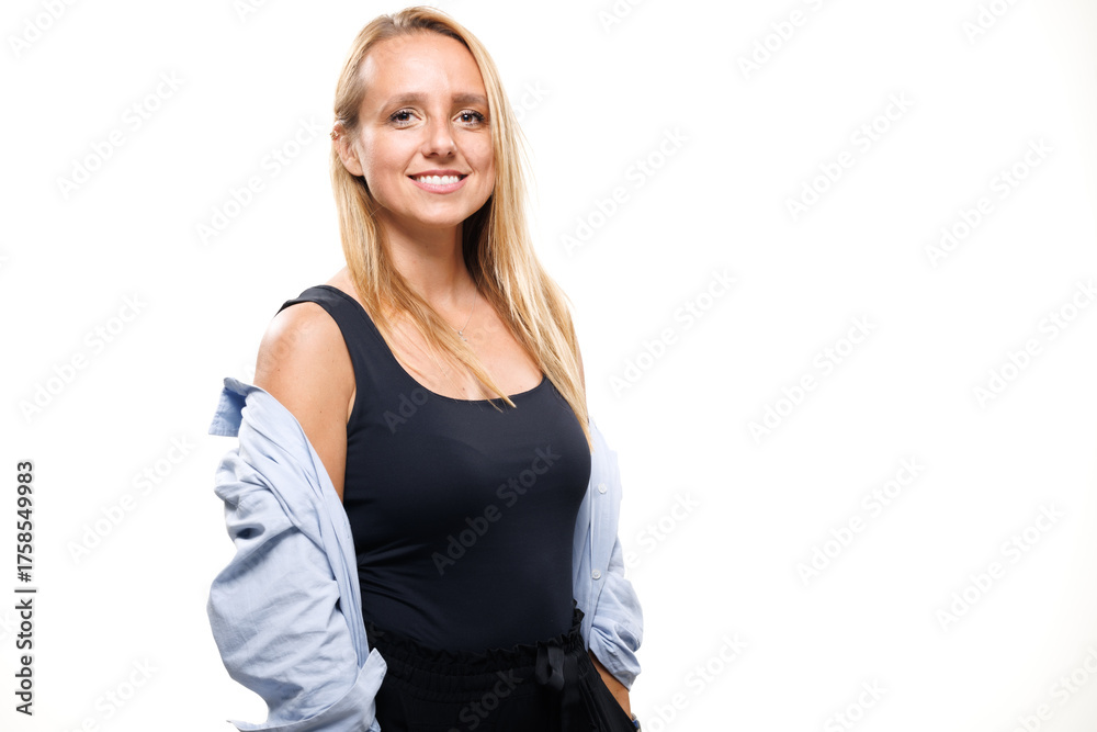 Fototapeta premium Confident businesswoman posing in a casual outfit with a light shirt, showcasing her professional demeanor in a bright studio setting