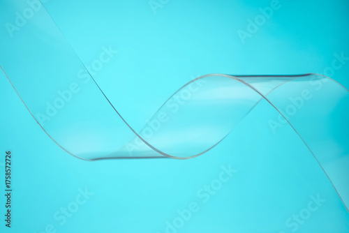 Transparent plastic wave on red background