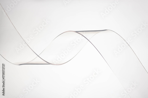 Transparent plastic wave on grey background