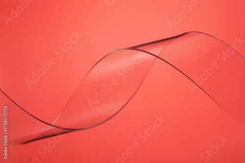 Transparent plastic wave on red background