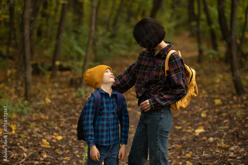 Fototapeta premium Mother with kid child boy son hiking in autumn forest.