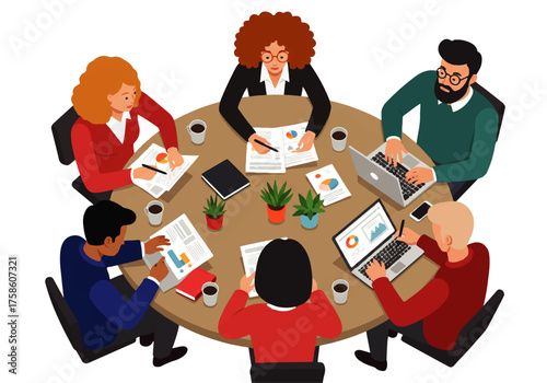 A diverse group of professionals sits around a round table, reviewing documents and working on laptops in a meeting.