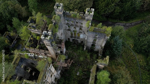Low level aerial image over a derelict castle on a bright sunny spring day on the rural landscape of central Scotland. 