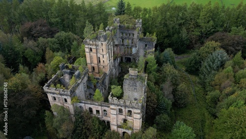 Low level aerial image over a derelict castle on a bright sunny spring day on the rural landscape of central Scotland. 