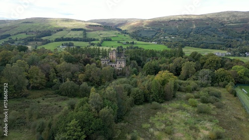 Low level aerial image over a derelict castle on a bright sunny spring day on the rural landscape of central Scotland. 
