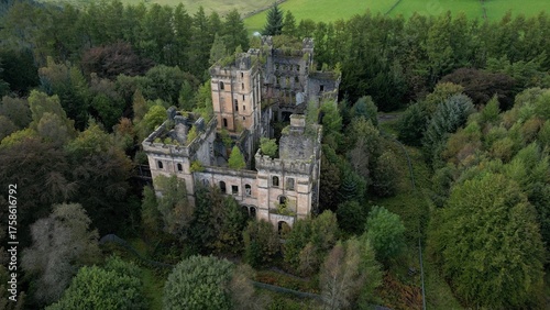 Low level aerial image over a derelict castle on a bright sunny spring day on the rural landscape of central Scotland. 