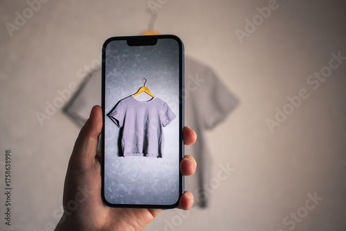 Woman photographs her old outfits for resale. Online resale platforms. Save planet and ecology concept.