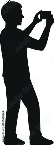 Silhouette of a person capturing a photo with a mobile phone