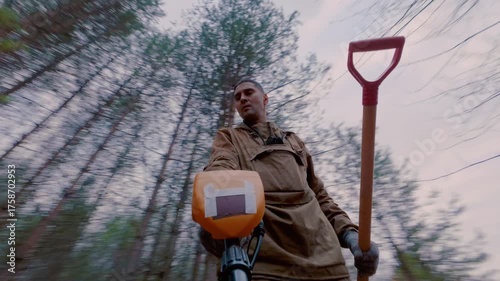 A guy with a metal detector is looking for metal and coins in the ground. The process of searching for metal products. Gambling search engine.