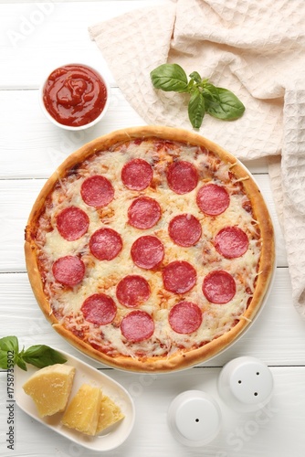 Fotografía Delicious pepperoni pizza and ingredients on white wooden table, flat lay