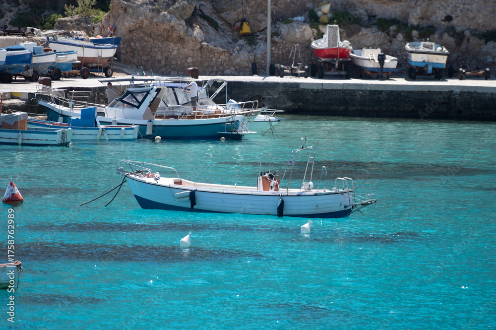 Fototapeta premium Levanzo, smallest of Egadi Islands, tranquil retreat near Sicily, picturesque village around harbor, white houses and charming blue-water harbor, travel destination, boat trip