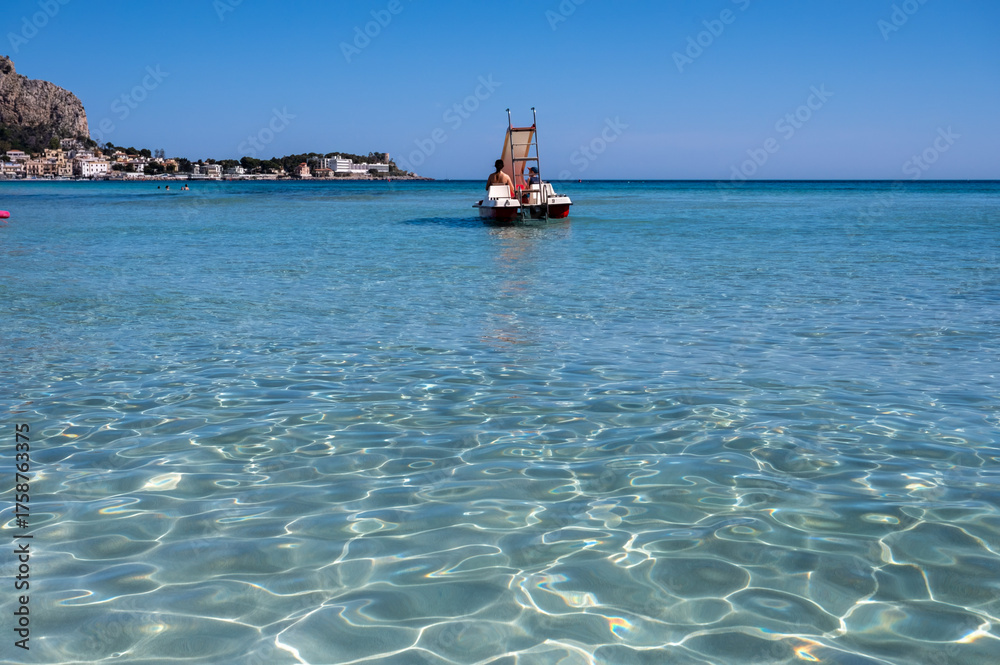 Obraz premium Sunny day on seaside vacation destination, Mondello Beach, near Palermo in Sicily with fine, golden sand, turquoise waters and charming villas, South of Italy