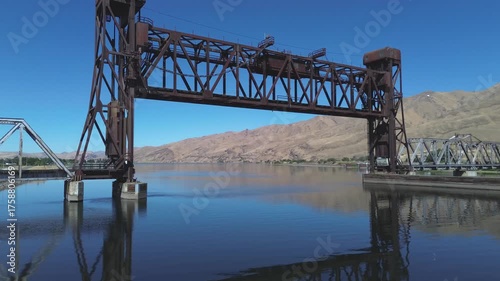 Railroad lift bridge over the Snake River in Lewiston Idaho. Very low, water level shot travels under the bridge. Setting is the high desert of Idaho on the Snake River.
