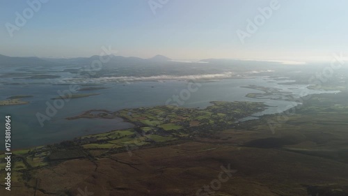 Breathtaking 4K aerial video of flying above scenic Atlantic Coast at Clew Bay with scenic coastline and islands at dawn, Murrisk, Westport, Mayo, Ireland