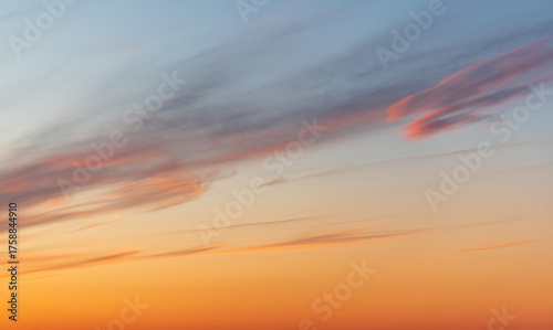 A tranquil sunset fills the sky with warm orange hues near the horizon