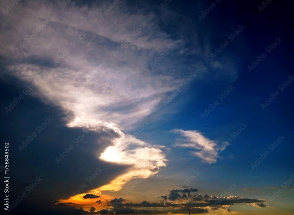 Fototapeta premium Golden sunset sky, Yellow sun dawn Orange sky clouds in the evening over the view of the hills mountains summer Golden hour Good nature background