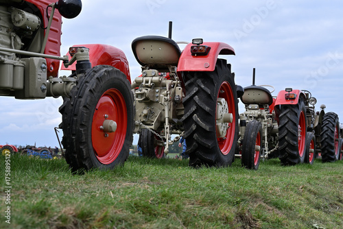 The historic tractors on a meadow agricultural machinery