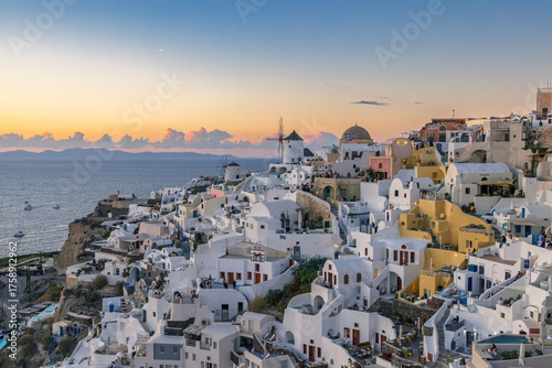 Stunning Sunset View of Oia Village in Santorini, Greece, with Iconic White-Washed Houses and Aegean Sea