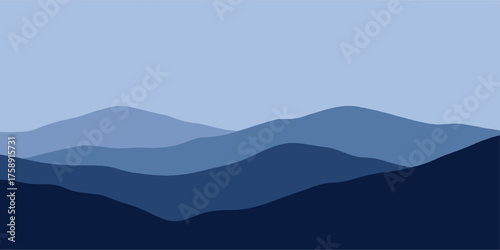 Mountain landscape with a fog and mist at sunrise over the valley and hills