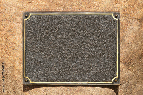 Bild auf Leinwand Empty metal plaque on stone wall background