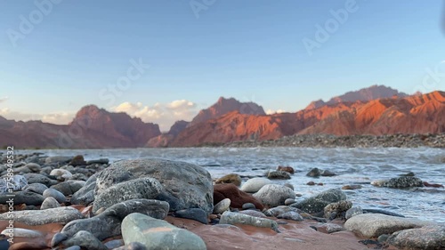 time-lapse of sunset over mountains and flowing river in tianshan mysterious grand canyon, xinjiang, china